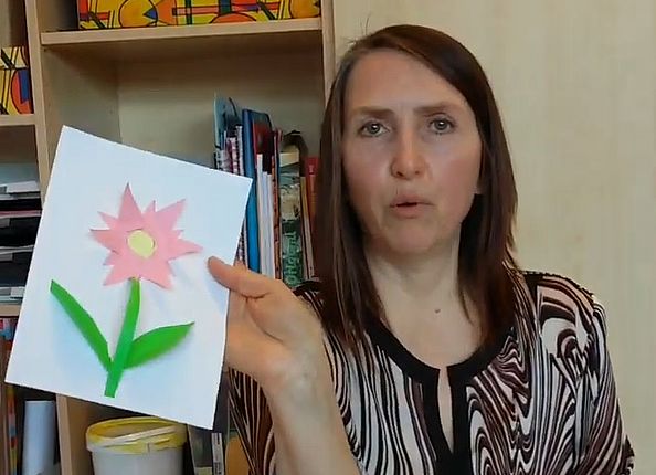 Oxana zeigt ein Bild ihrer gebastelten Muttertagsblume in die Kamera
